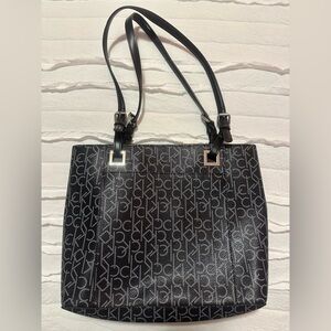 New Calvin Klein black tote, CK logo, adjustable straps, and metal accents.